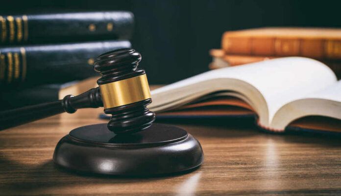 Law,Studies.,Judge,Gavel,On,A,Wooden,Desk,,Blur,Legal Judge's gavel on desk with open law book