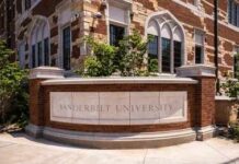 Campus War Erupts Over ‘Rigged’ Research Historic brick university building with central tower framed by green trees