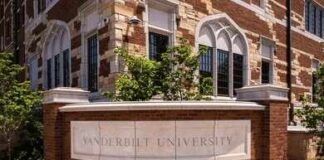 Campus War Erupts Over ‘Rigged’ Research Historic brick university building with central tower framed by green trees