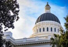 California Corruption Probe Widens Again View of a state capitol dome with American and California flags against a blue sky