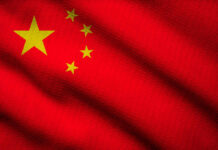 Pacific JOLT: China’s Sub Test Sparks Fury Close-up of the Chinese flag featuring a red background and yellow stars