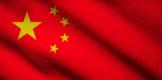 Pacific JOLT: China’s Sub Test Sparks Fury Close-up of the Chinese flag featuring a red background and yellow stars