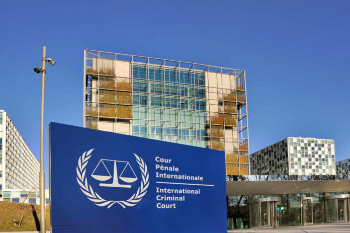 The,Hague,,Netherlands,-,February,14,2018:,The,International,Criminal,Court International Criminal Court building with blue sign in front