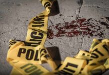 Point-Blank Killing Inside Mayor’s Office Crime scene tape near blood on pavement