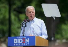 Biden’s Secret Recordings Finally Released? man speaking at an outdoor podium with microphones