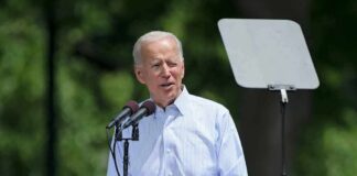 Biden’s Secret Recordings Finally Released? man speaking at an outdoor podium with microphones