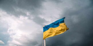Ukrainian flag waving against a stormy sky