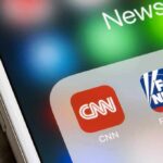 smartphone screen showing CNN and Fox News app icons