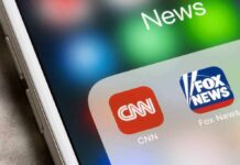 CNN Hype Collides With Court Reality smartphone screen showing CNN and Fox News app icons