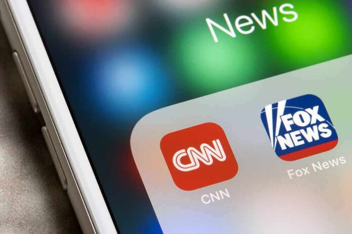 shutterstock_1907221756 smartphone screen showing CNN and Fox News app icons