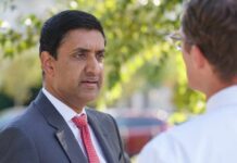 Congressman Challenges Israel’s Version Two professionals engaged in a conversation outdoors