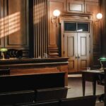 Empty courtroom with wooden benches and judge’s bench