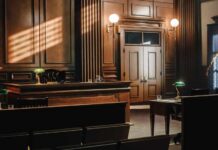 Empty courtroom with wooden benches and judge’s bench