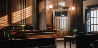 Empty courtroom with wooden benches and judge’s bench