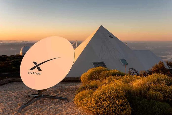 shutterstock_2133739611 Starlink satellite dish near a pyramid-shaped building at sunset