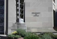 DOJ Escalates War On Terror Gang Department of Justice building exterior with stone facade and plants