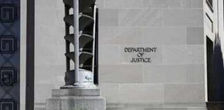 DOJ Escalates War On Terror Gang Department of Justice building exterior with stone facade and plants