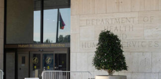 New Plague Case Raises Concerns Entrance of the Hubert H. Humphrey Building with a decorative plant and a flag visible