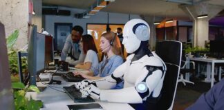xAI Makes A Surprising Court Move Robot and office workers at computers in a modern workspace
