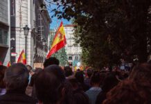 World Cup Fever Rewires Midtown Crowd with Spanish flags in a city street