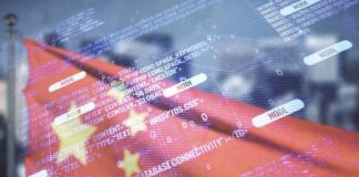 Weak Demand Hits China’s Economy Overlay of programming code on a blurred Chinese flag
