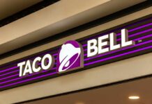 Parasite Outbreak Tied To Taco Bell Taco Bell storefront sign with purple bell logo
