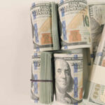 Stacks of hundred dollar bills arranged neatly