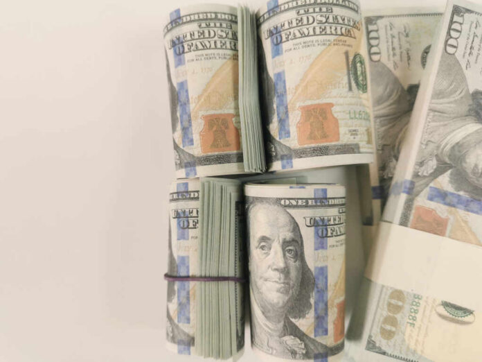 shutterstock_2495532515 Stacks of hundred dollar bills arranged neatly