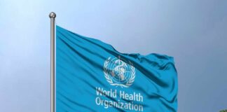 Ebola Response Faces New Obstacles Flag of the World Health Organization waving against a blue sky