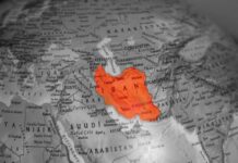 Iran Strike Claims Face Questions Map highlighting Iran in orange on a grayscale background