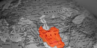 Iran Strike Claims Face Questions Map highlighting Iran in orange on a grayscale background