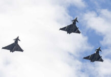 U.S.-Iran Conflict Escalates Again Three fighter jets flying in formation against a cloudy sky