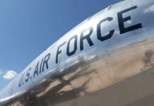Inside America’s Massive B-21 Investment Close-up of a U.S. Air Force aircraft with a shiny metallic surface against a blue sky