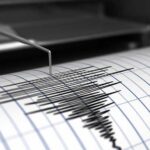 Seismograph needle recording earthquake waves on paper
