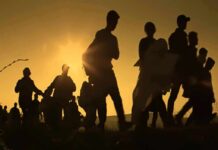 Europe Faces A Migration Breaking Point Silhouettes of people walking at sunset