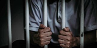 Multiple Women Report Assaults In Oklahoma City person gripping prison bars