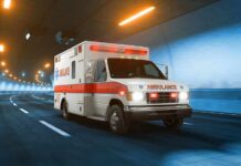 Ambulance driving through a tunnel with emergency lights on