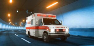 Families Flee As Shots Rip Through In‑N‑Out Ambulance driving through a tunnel with emergency lights on