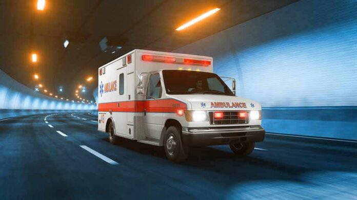 Ambulance driving through a tunnel with emergency lights on