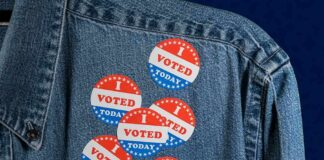 DOJ Probes Jersey’s Voter Roll Fiasco denim jacket with multiple red white and blue voting stickers