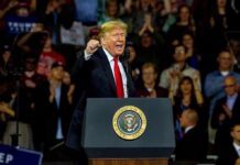 Trump Takes Aim At America’s Drug Costs man speaking at a podium during a rally