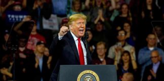 Trump Takes Aim At America’s Drug Costs man speaking at a podium during a rally