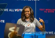 woman speaking at a podium during a voting event