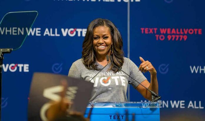 shutterstock_1329500510 woman speaking at a podium during a voting event