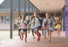 More Schools Are Crossing A Risky Line Children running through a school hallway with backpacks