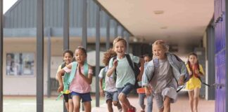 More Schools Are Crossing A Risky Line Children running through a school hallway with backpacks