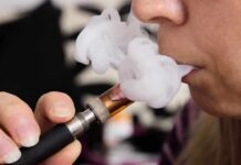 Battery Fires Spark Vape Crackdown Close-up of a person vaping, exhaling smoke clouds