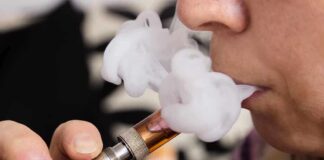 Battery Fires Spark Vape Crackdown Close-up of a person vaping, exhaling smoke clouds