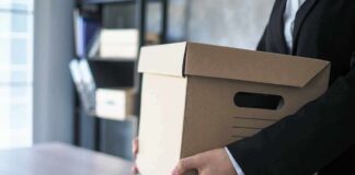 The Labor Market’s Hidden Warning Emerges person in a suit carrying a cardboard storage box
