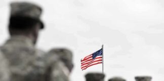 Alliance RIFT Over Trump’s Drill Cut American flag above blurred soldiers in formation